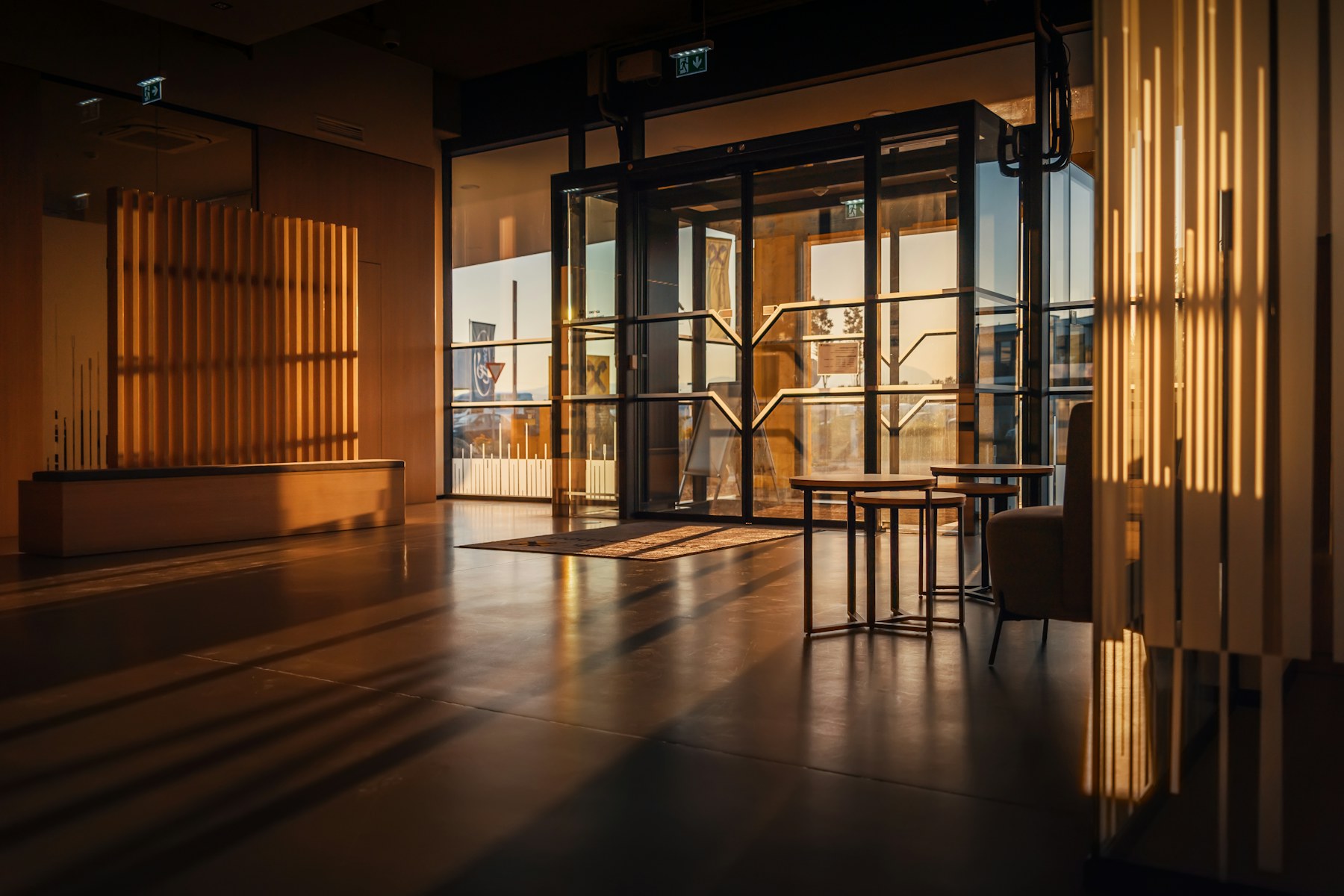 A warm, modern brokerage office interior with soft daylight.