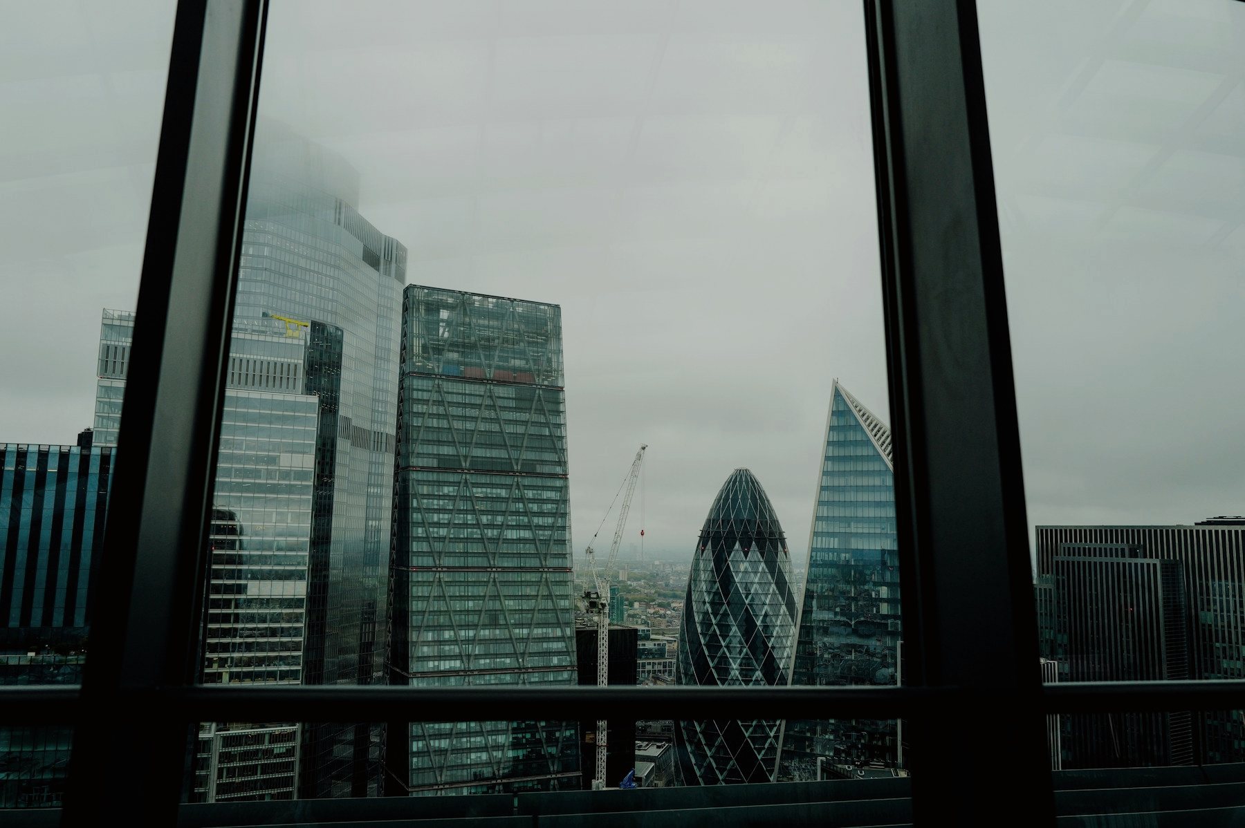 The City of London skyline seen through a window: the Gherkin, the Cheesegrater and the Scalpel.