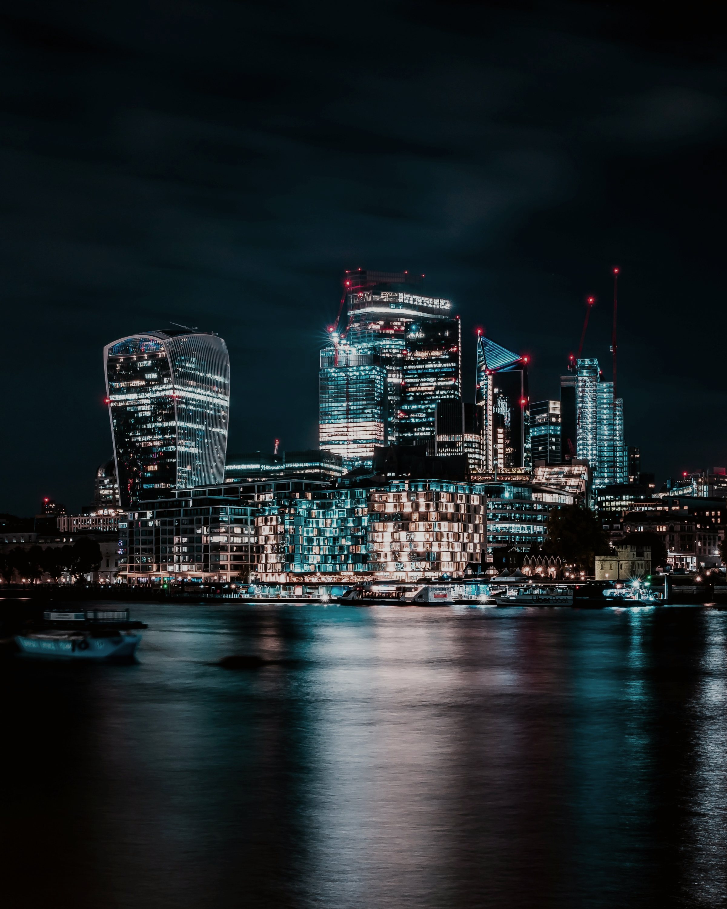 The City of London financial district at night, viewed across the Thames